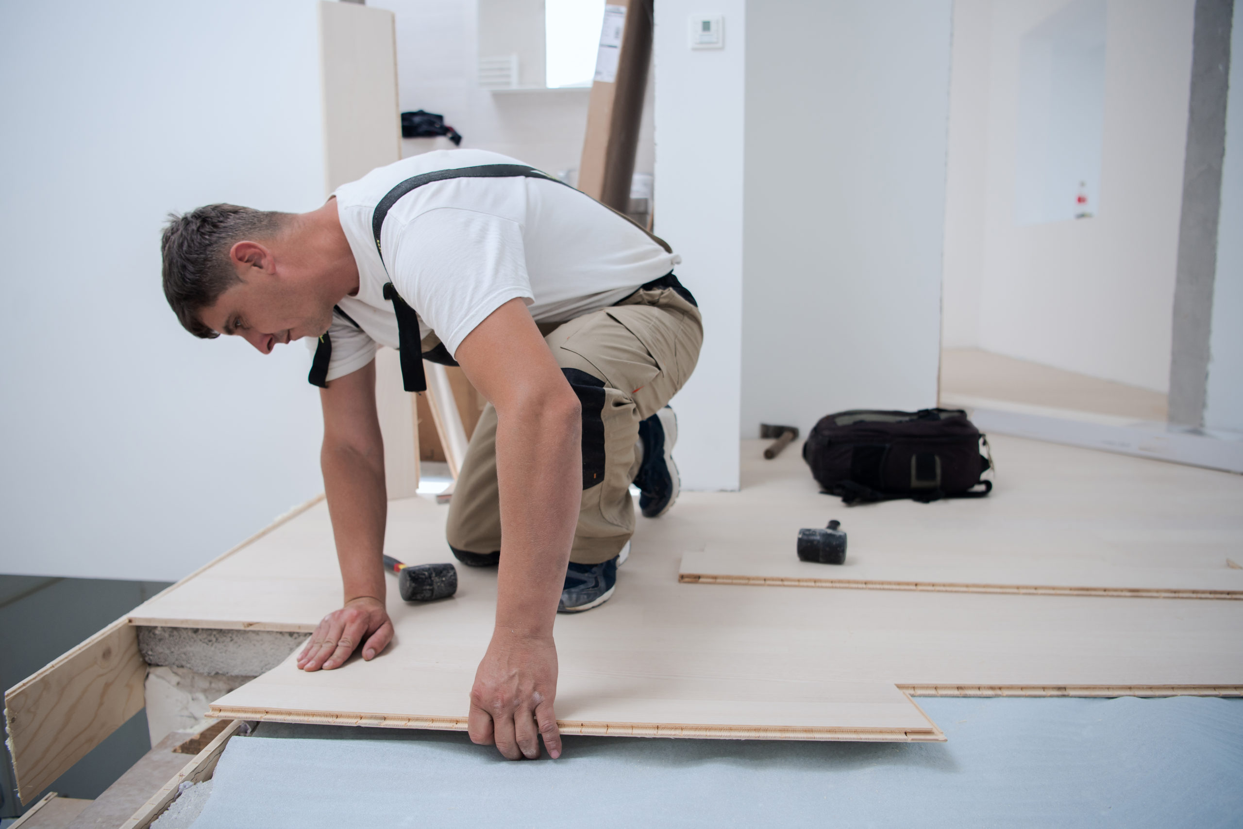 Worker Installing New Laminated Wooden Floor